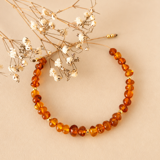 Pulsera de ámbar con balines bañados de oro